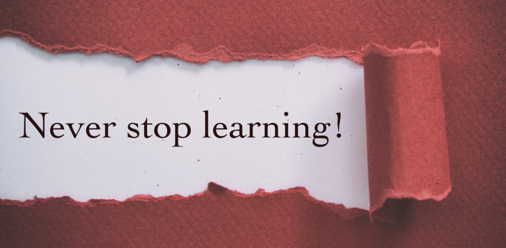 The Training Development of People in The Workplace: How to Successfully Manage a Trainee - red paper ripping with the words 'never stop learning'