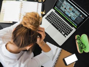 Person looking stressed over a laptop