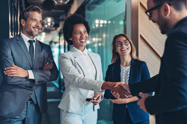 Group of business persons shaking hands in software development