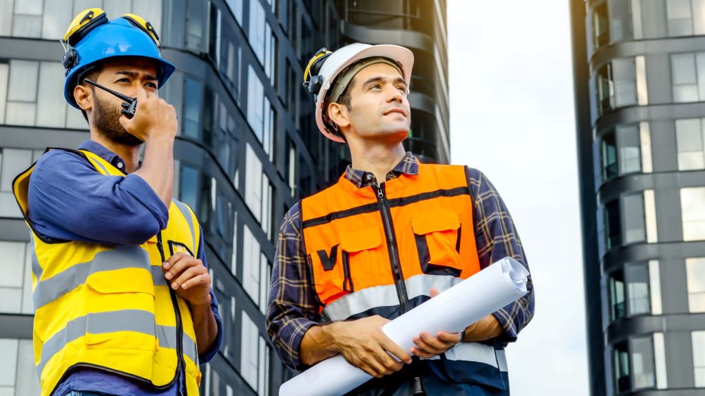 Two people in hi-vis jackets looking at engineering work