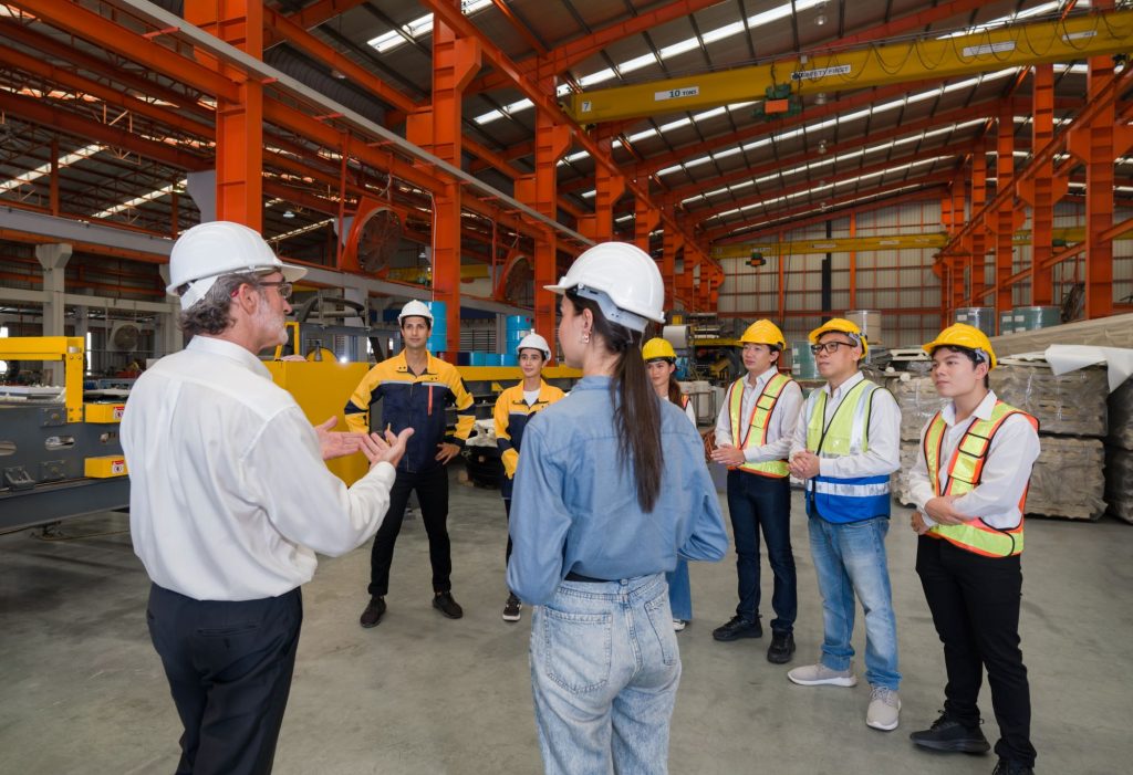 Multiple people having a meeting in a warehouse